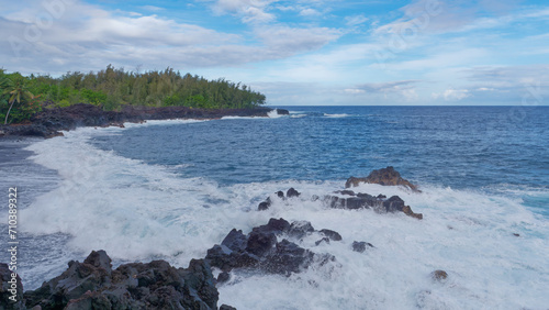 Waves crashing at rocks at Kehena black sand beach in the Big Island's Puna district, Hawaii