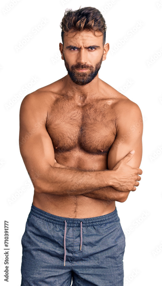 Young hispanic man wearing swimwear shirtless skeptic and nervous, disapproving expression on face with crossed arms. negative person. Young hispanic man wearing swimwear shirtless skeptic and nervous, disapproving expression on face with crossed arms. negative person.