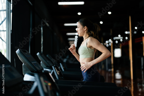 Young Asian Woman Running on Treadmill - Fitness Gym Exercise