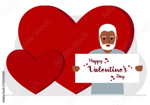 A man holds a Happy Valentine's Day greeting against a background of red hearts.