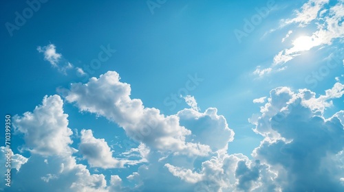 A clear blue sky with fluffy clouds lazily drifting overhead