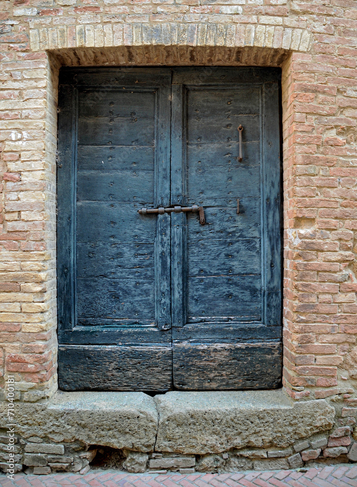Old wooden door of a brick building
