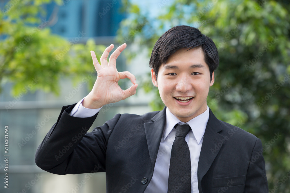 Asian business man gesturing okay Asian business man gesturing okay