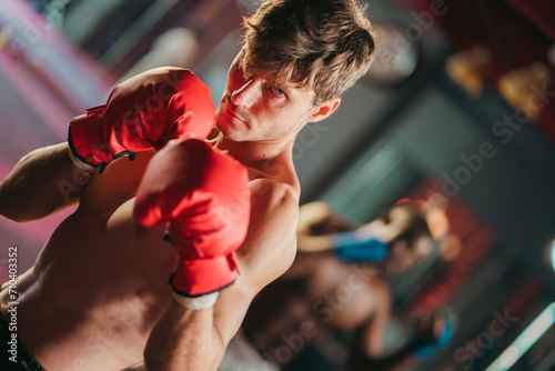 Caucasian muscular male Muay Thai boxer is doing a punching strong and powerful posture in gym or sport center, A professional and expert boxer or athlete in fitness center with copy space backgrounds