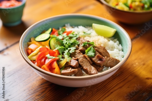 fajita bowl with rice, beans, meat, and vegetables