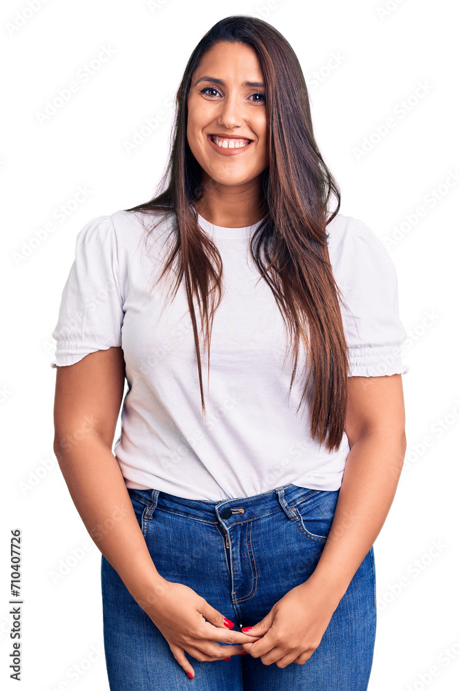 Young beautiful brunette woman wearing casual t-shirt looking positive and happy standing and smiling with a confident smile showing teeth Young beautiful brunette woman wearing casual t-shirt looking positive and happy standing and smiling with a confident smile showing teeth