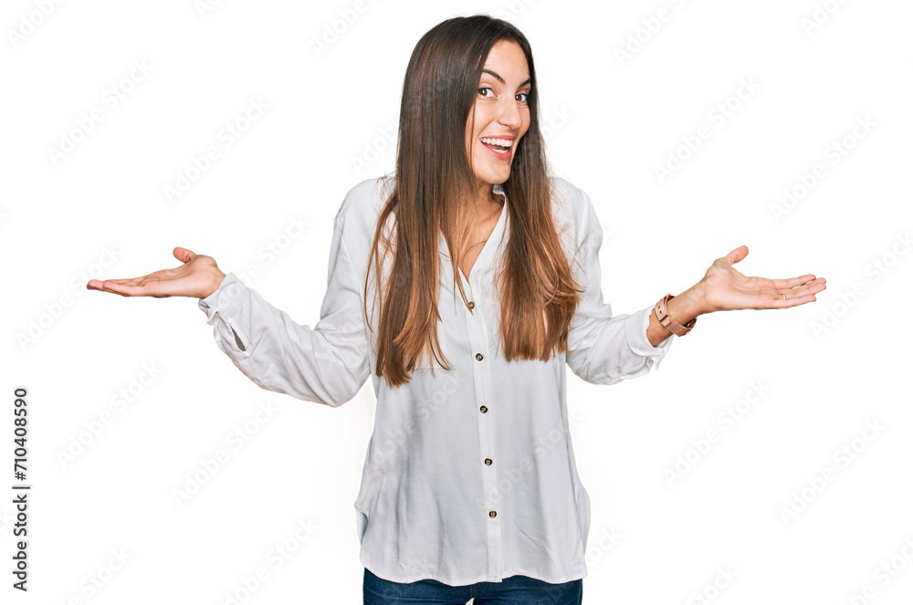 Young beautiful woman wearing casual clothes smiling showing both hands open palms, presenting and advertising comparison and balance Young beautiful woman wearing casual clothes smiling showing both hands open palms, presenting and advertising comparison and balance