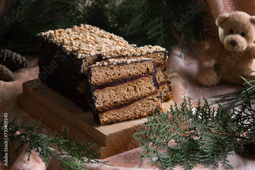 Piernik staropolski traditional christmas layered gingerbread  honey cake with plum jam on wooden board, selective focus