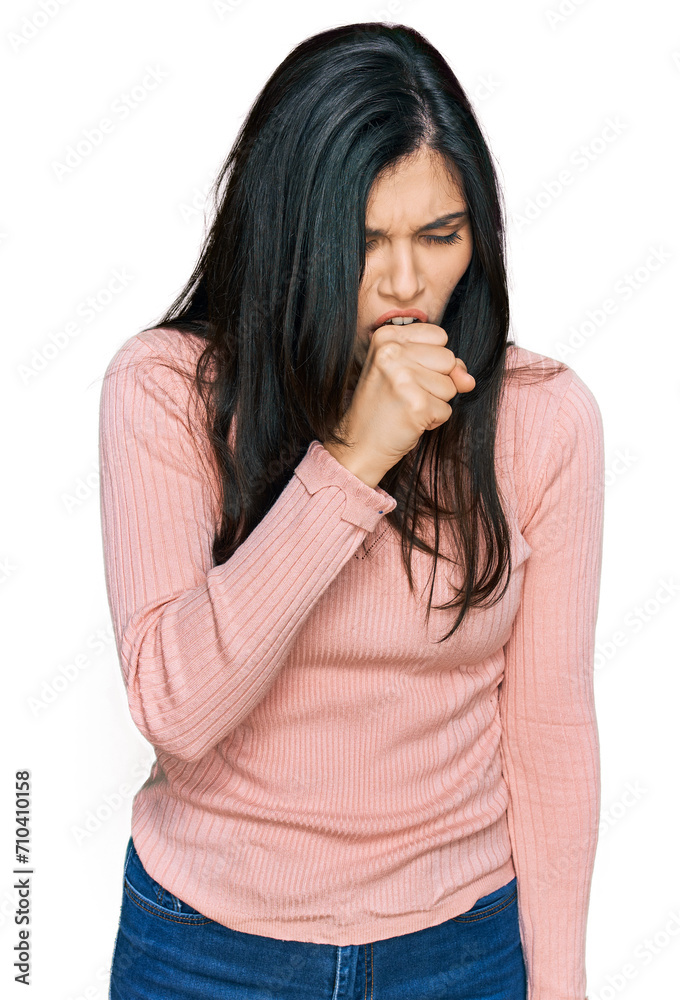 Young hispanic woman wearing casual clothes feeling unwell and coughing as symptom for cold or bronchitis. health care concept. Young hispanic woman wearing casual clothes feeling unwell and coughing as symptom for cold or bronchitis. health care concept.