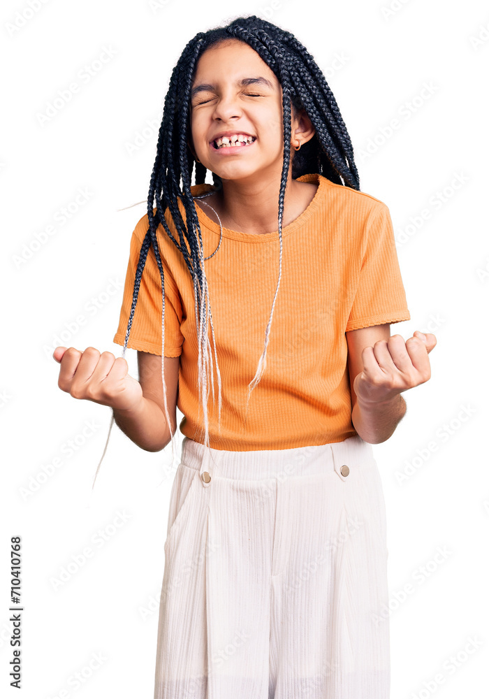 Cute african american girl wearing casual clothes very happy and excited doing winner gesture with arms raised, smiling and screaming for success. celebration concept. Cute african american girl wearing casual clothes very happy and excited doing winner gesture with arms raised, smiling and screaming for success. celebration concept.