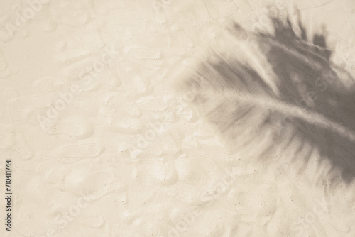 Fototapeta Naklejka Na Ścianę i Meble -  Shadows of palm tree branches on the sand. Tropical beach tourism. Summer natural background.