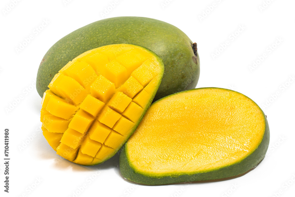 Sliced half cut into cubes and whole fresh organic green mango delicious fruit side view isolated on white background clipping path