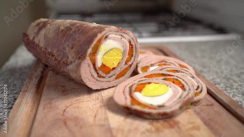 Slices Of Matambre Arrollado (Argentinian Stuffed Flank Steak) On Wooden Chopping Board. closeup shot photo