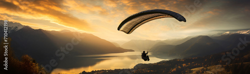 Man paragliding above lake lake rosetta, in the style of photo-realistic landscapes, golden light, dark gold and orange

 photo