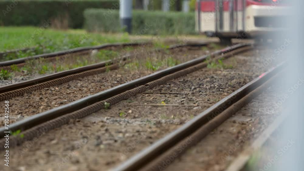 Railway tracks converge in the distance with a blurry train approaching, suggesting motion and travel. Railway tracks converge in the distance with a blurry train approaching, suggesting motion and travel.