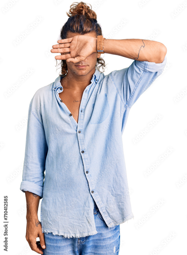 Young hispanic man wearing summer style covering eyes with arm, looking serious and sad. sightless, hiding and rejection concept Young hispanic man wearing summer style covering eyes with arm, looking serious and sad. sightless, hiding and rejection concept