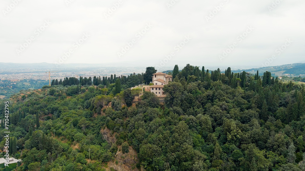 Florence, Italy. Villa on a mountain covered with forest. Suburb. Summer, Aerial View