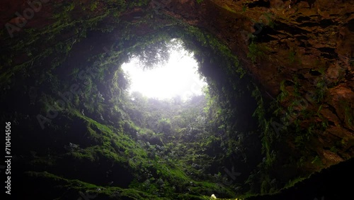 Raindrops fall through Algar do Carvao hole in Terceira, Azores photo