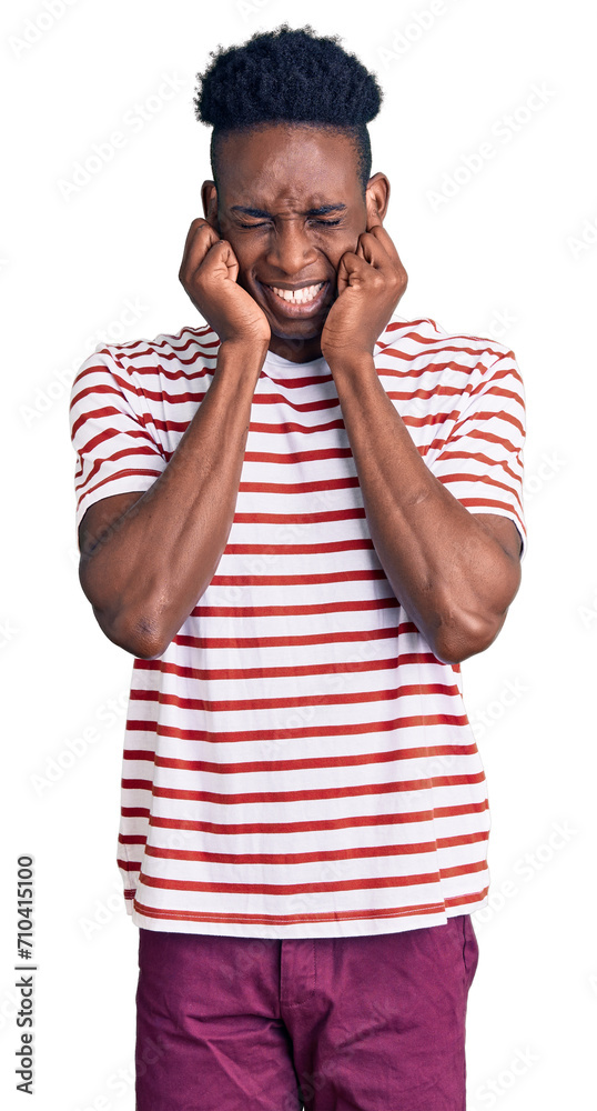 Young african american man wearing casual clothes covering ears with fingers with annoyed expression for the noise of loud music. deaf concept. Young african american man wearing casual clothes covering ears with fingers with annoyed expression for the noise of loud music. deaf concept.