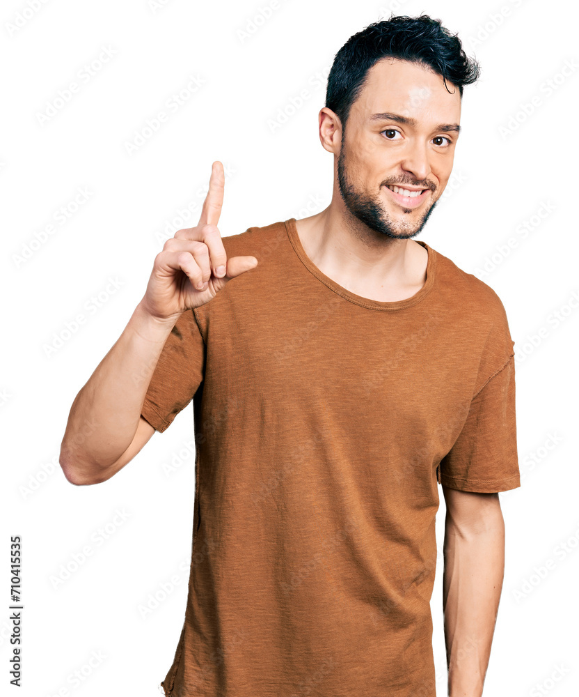 Hispanic man with beard wearing casual t shirt smiling with an idea or question pointing finger up with happy face, number one Hispanic man with beard wearing casual t shirt smiling with an idea or question pointing finger up with happy face, number one