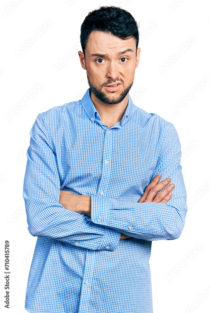 Hispanic man with beard with arms crossed gesture clueless and confused expression. doubt concept. Hispanic man with beard with arms crossed gesture clueless and confused expression. doubt concept.