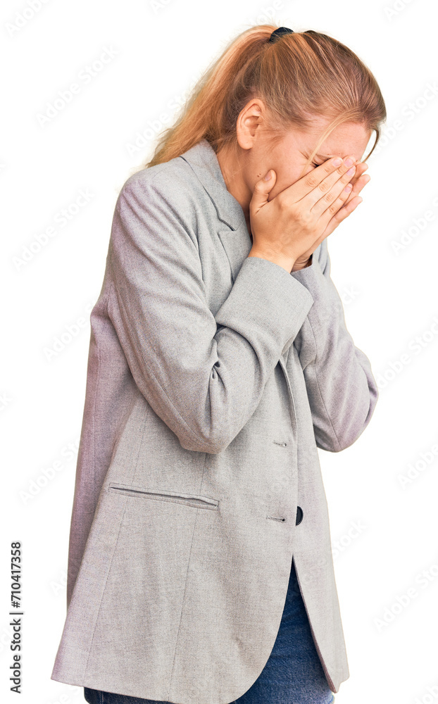 Young beautiful blonde woman wearing elegant jacket with sad expression covering face with hands while crying. depression concept. Young beautiful blonde woman wearing elegant jacket with sad expression covering face with hands while crying. depression concept.