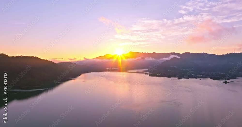 Aerial video of beautiful lake and mountain with sun natural landscape at sunrise in Hangzhou. Drone ascending to shoot. Aerial video of beautiful lake and mountain with sun natural landscape at sunrise in Hangzhou. Drone ascending to shoot.