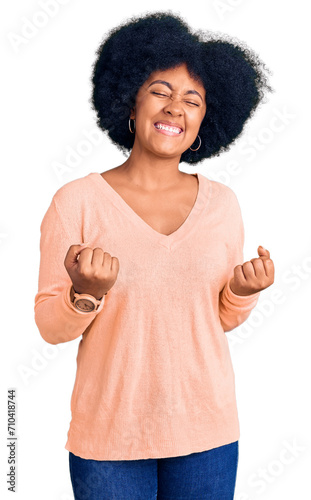 Young african american girl wearing casual clothes very happy and excited doing winner gesture with arms raised, smiling and screaming for success. celebration concept.