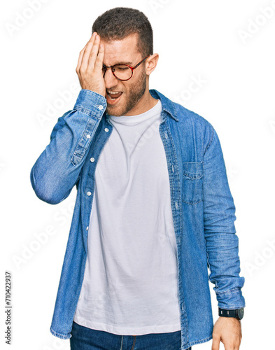 Young caucasian man wearing casual clothes yawning tired covering half face, eye and mouth with hand. face hurts in pain. photo