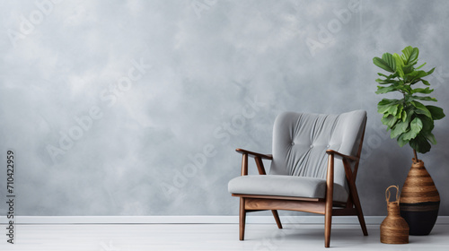 Comfortable armchair near light grey wall indoors. © Anas