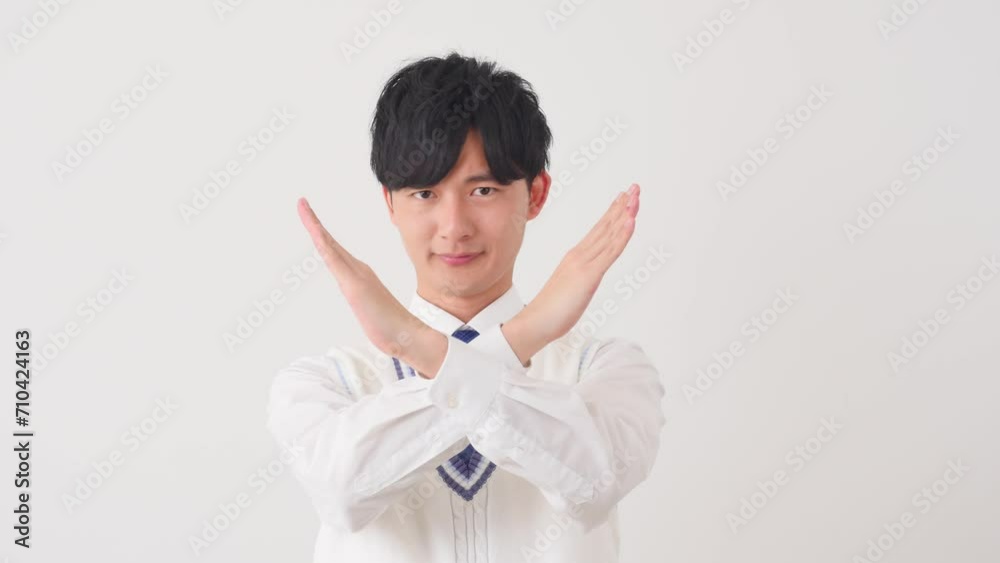 腕でばつ印をする男子高校生 白背景 腕でばつ印をする男子高校生 白背景