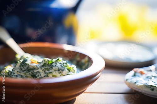close-up of spinach raita with a dab of butter
