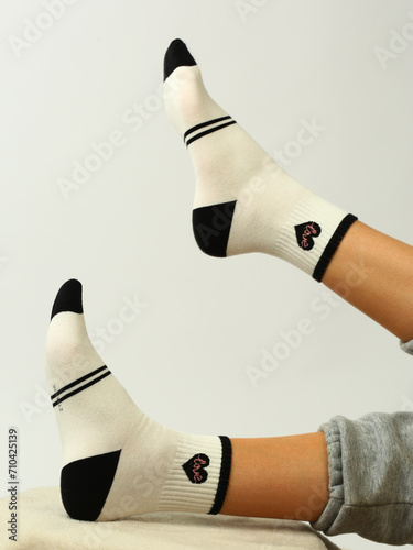 white sock with copy space on human foot closeup photo on white background