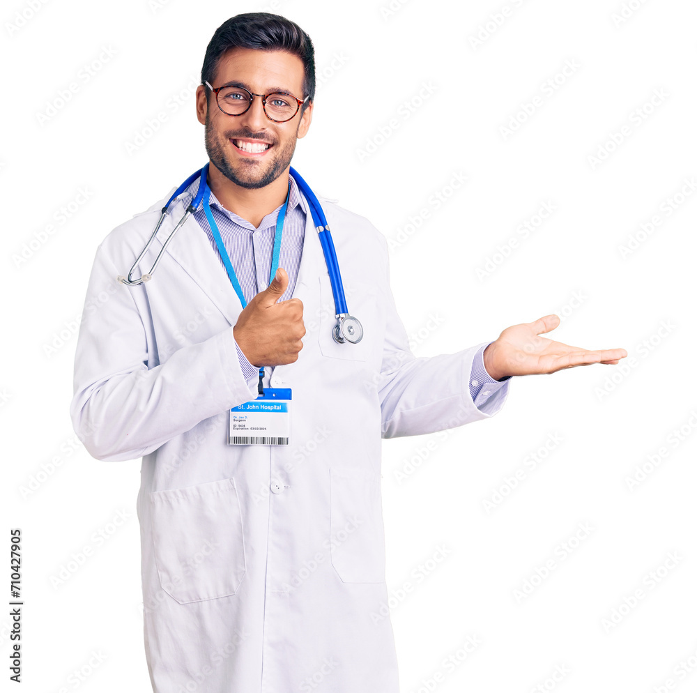 Young hispanic man wearing doctor uniform and stethoscope showing palm hand and doing ok gesture with thumbs up, smiling happy and cheerful Young hispanic man wearing doctor uniform and stethoscope showing palm hand and doing ok gesture with thumbs up, smiling happy and cheerful