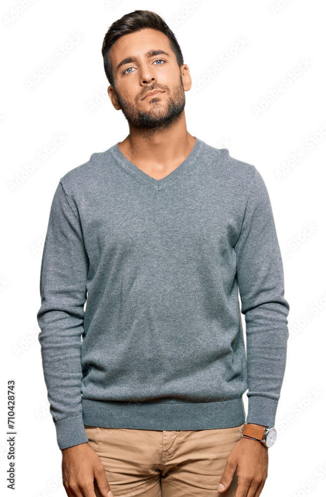 Fototapeta premium Handsome hispanic man wearing casual clothes relaxed with serious expression on face. simple and natural looking at the camera.