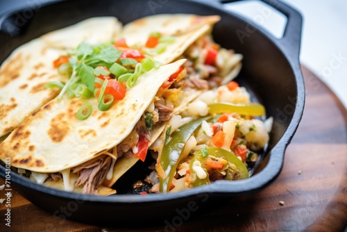 sizzling quesadilla on cast iron skillet side view