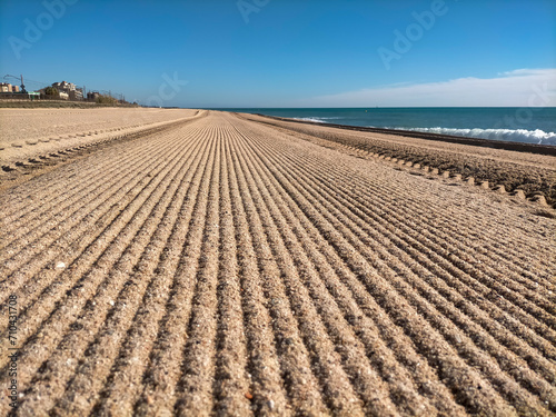 Vilassar de Mar-Barcelona beach, first thing in the morning in summer, freshly brushed with the tractor.
Horizontal lines are observed that disappear along the beach, blue sky and the Mediterranean Se photo
