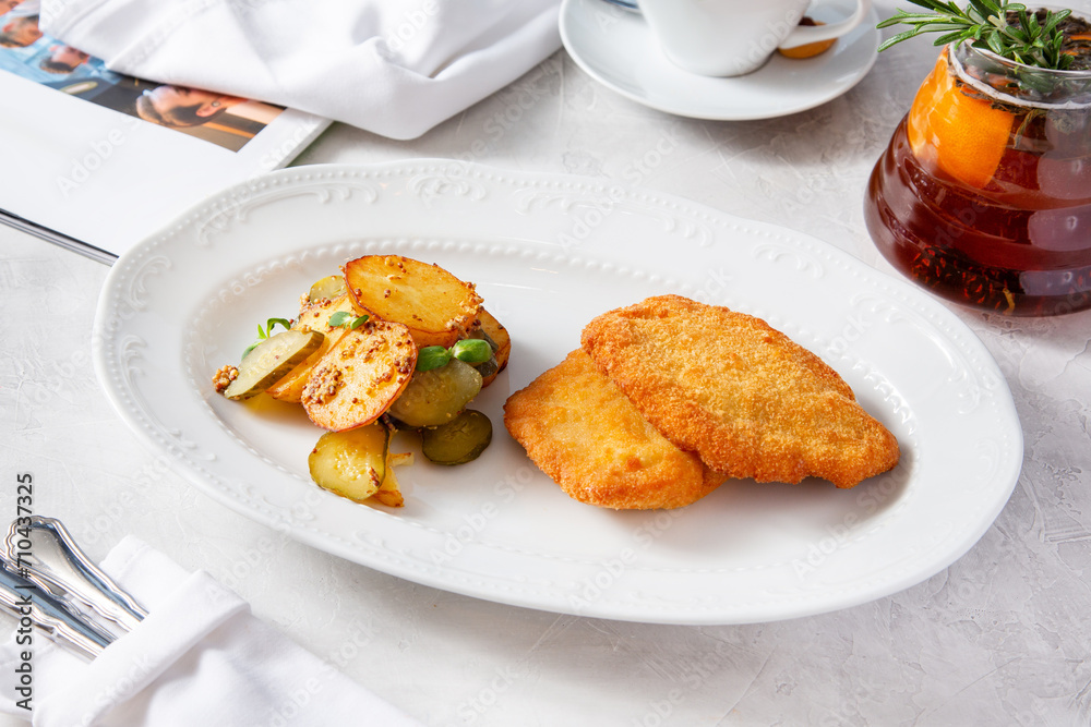 Pork schnitzel, pork cutlet with potatoes on a plate. Pork schnitzel, pork cutlet with potatoes on a plate.
