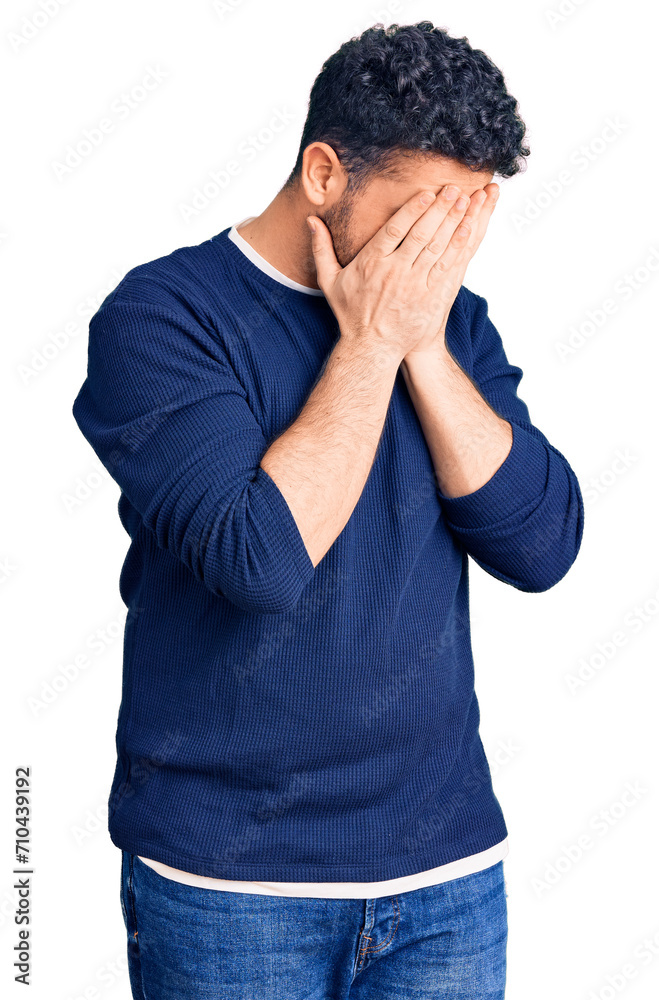 Young hispanic man wearing casual clothes with sad expression covering face with hands while crying. depression concept. Young hispanic man wearing casual clothes with sad expression covering face with hands while crying. depression concept.