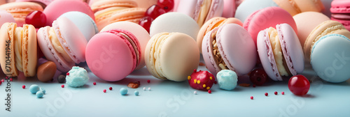Colorful french desserts with sweets, top view, flat lay. Cake macaroons on plain background, colorful almond cookies, pastel colors. Banner. Flat lay, top view photo