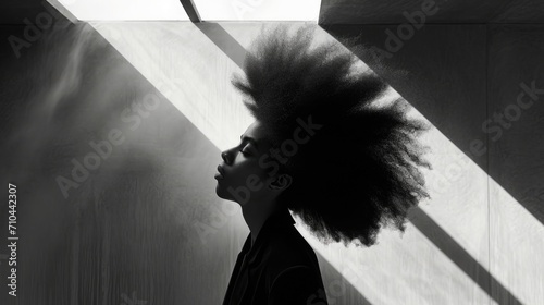 Photo of a African woman with a Dramatic, Asymmetrical Hair Style, standing out in a minimalist, brightly lit space photo