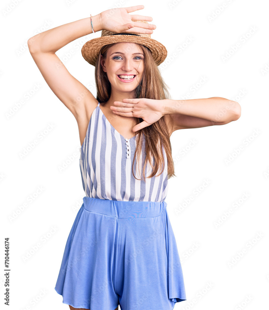 Young beautiful blonde woman wearing summer hat smiling cheerful playing peek a boo with hands showing face. surprised and exited Young beautiful blonde woman wearing summer hat smiling cheerful playing peek a boo with hands showing face. surprised and exited
