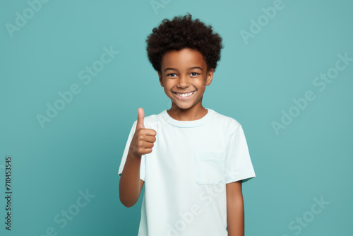 Joyful Child Showing Approval with Thumbs Up photo