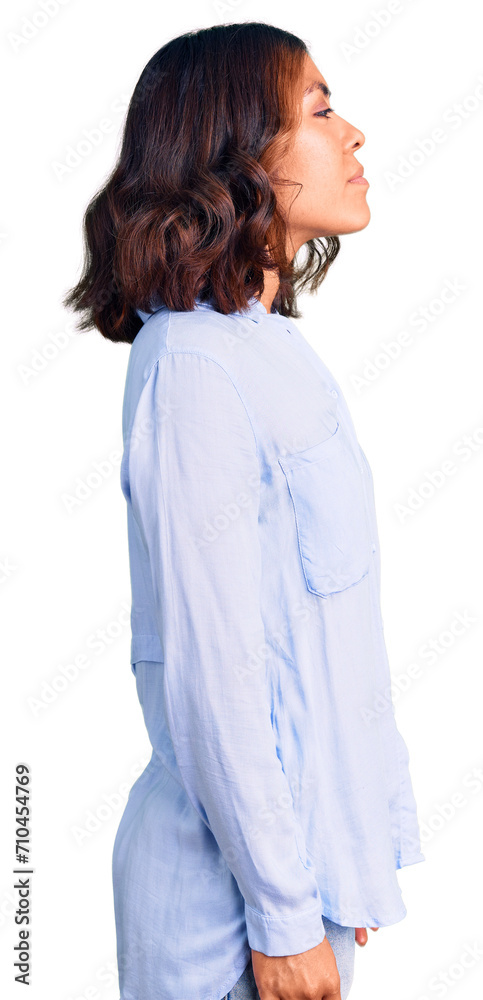 Young beautiful mixed race woman wearing casual business shirt looking to side, relax profile pose with natural face with confident smile. Young beautiful mixed race woman wearing casual business shirt looking to side, relax profile pose with natural face with confident smile.