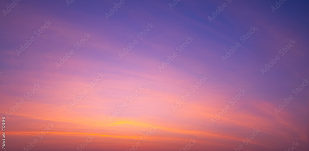 Sunset sky background with beautiful pink sunrise clouds on colorful dramatic twilight sky in panoramic view  - obrazy, fototapety, plakaty 