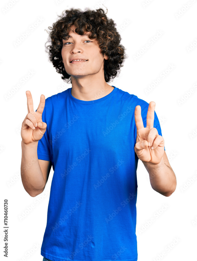 Φωτογραφία Caucasian teenager wearing casual clothes smiling looking to the camera showing fingers doing victory sign