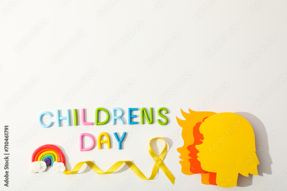Children's heads made of paper with a yellow ribbon Children's heads made of paper with a yellow ribbon