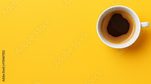 Top view of coffee cup on yellow background