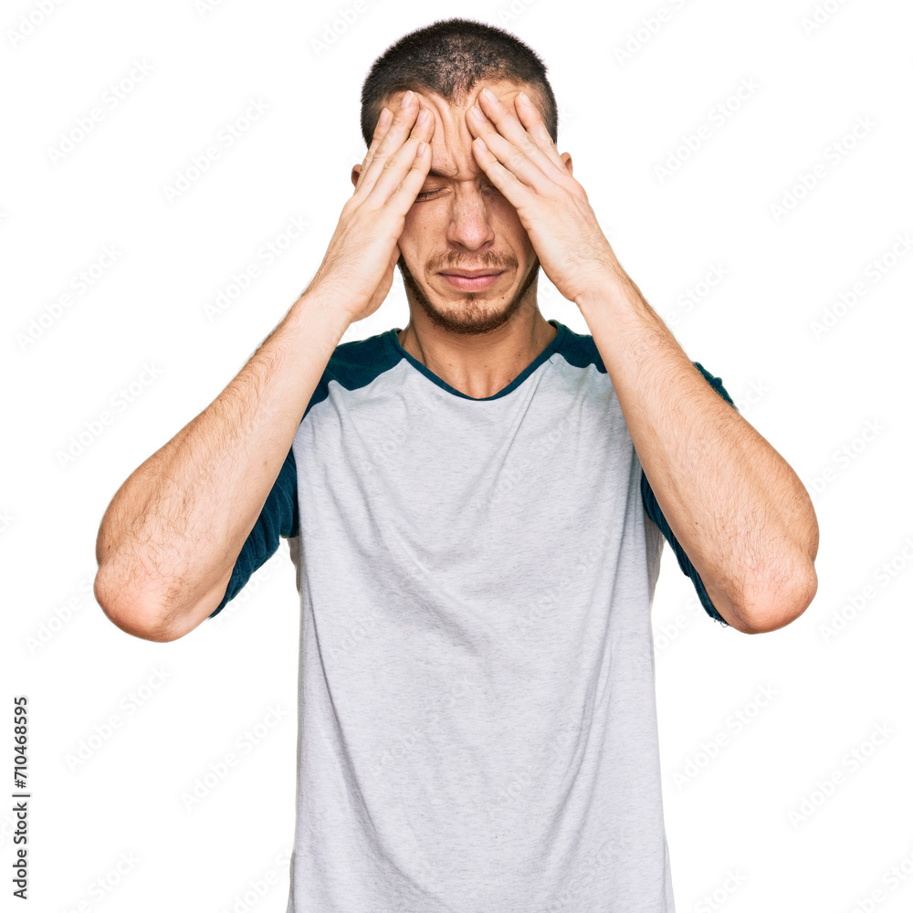 Fototapeta premium Hispanic young man wearing casual clothes suffering from headache desperate and stressed because pain and migraine. hands on head.