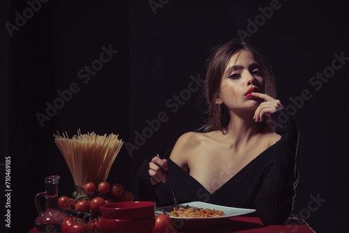 Eating Spaghetti pasta. Portrait of young Woman Eating Spaghetti pasta. Eating pasta. Woman eat spaghetti with sauce. Good pasta. Girl eats spaghetti. Healthy eating. Sexy kitchen. Finger lick mouth.